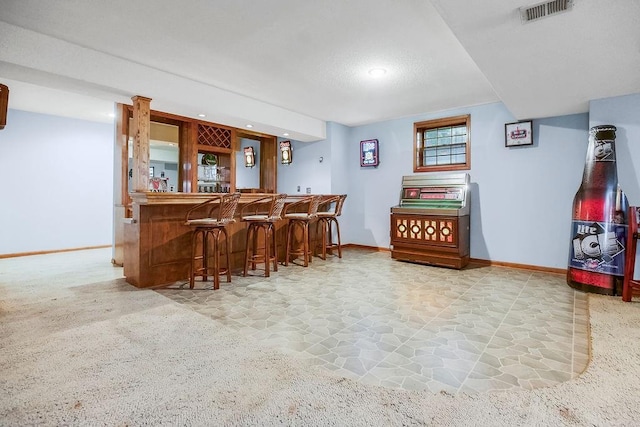 12808 Howe Dr, Leawood, KS 66209 - indoor wet bar featuring baseboards, stone finish flooring, and recessed lighting