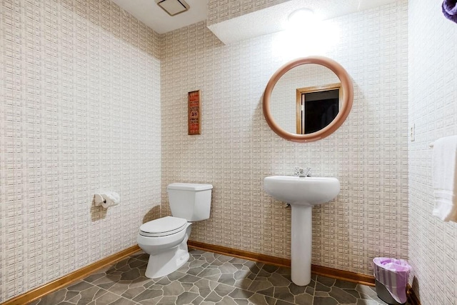 12808 Howe Dr, Leawood, KS 66209 - half bathroom with baseboards, toilet, tile patterned flooring, and a sink