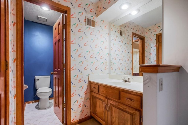 12808 Howe Dr, Leawood, KS 66209 - bathroom with wallpapered walls, toilet, vanity, a textured ceiling, and tile patterned floors