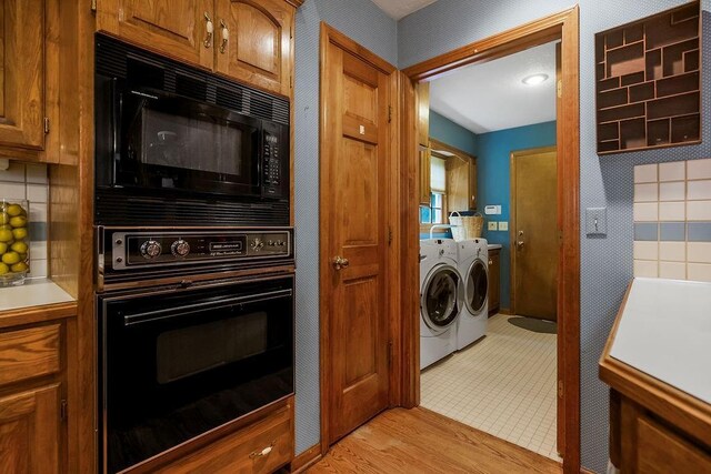 12808 Howe Dr, Leawood, KS 66209 - kitchen with black appliances, independent washer and dryer, brown cabinets, and light countertops