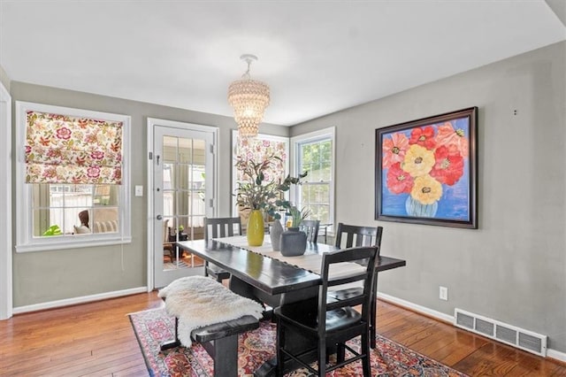 4111 W 69th St, Prairie Village, KS 66208 - dining room featuring a chandelier, hardwood / wood-style floors, and baseboards