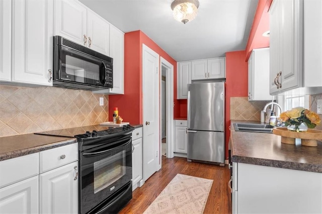 4111 W 69th St, Prairie Village, KS 66208 - kitchen with black appliances, a sink, dark countertops, and dark wood-style flooring