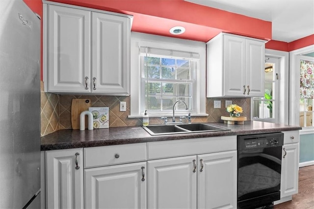 4111 W 69th St, Prairie Village, KS 66208 - kitchen with black dishwasher, a sink, freestanding refrigerator, and dark countertops