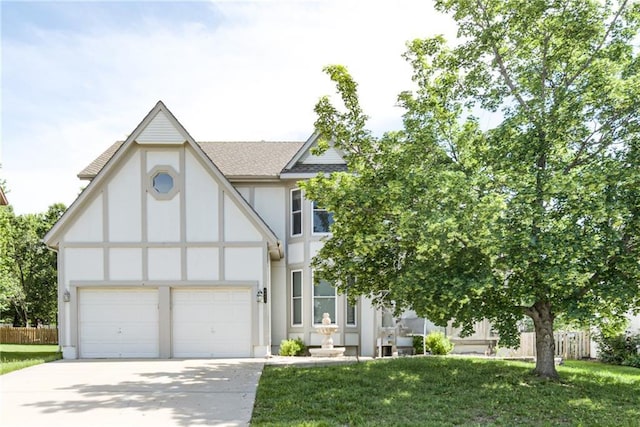 6402 W 147th Ter, Overland Park, KS 66223 - tudor-style house featuring stucco siding, concrete driveway, an attached garage, and a shingled roof