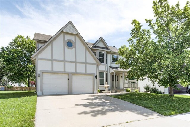 6402 W 147th Ter, Overland Park, KS 66223 - english style home with concrete driveway, stucco siding, an attached garage, and covered porch