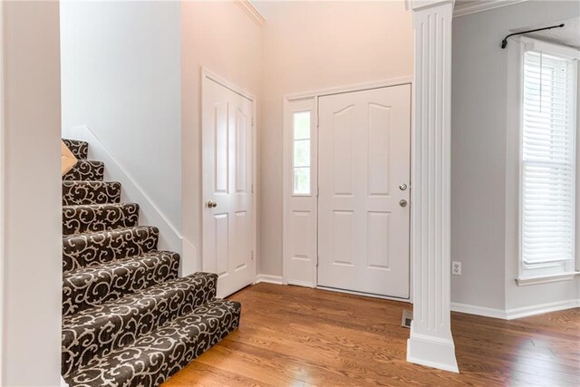 6402 W 147th Ter, Overland Park, KS 66223 - foyer with plenty of natural light, baseboards, wood finished floors, stairway, and crown molding