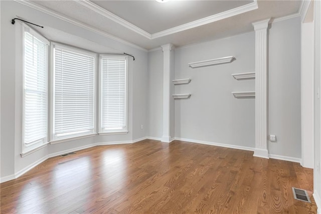 6402 W 147th Ter, Overland Park, KS 66223 - unfurnished living room featuring ornate columns, wood finished floors, crown molding, and baseboards