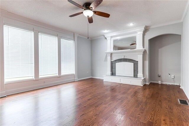 6402 W 147th Ter, Overland Park, KS 66223 - unfurnished living room featuring ornamental molding, ceiling fan, wood finished floors, a textured ceiling, and a tiled fireplace
