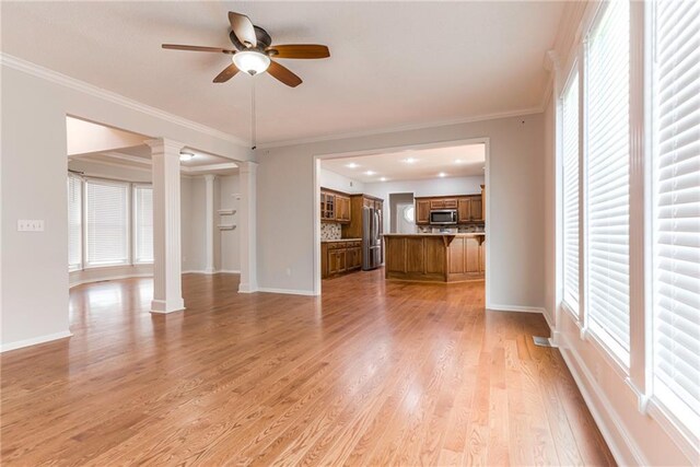 6402 W 147th Ter, Overland Park, KS 66223 - unfurnished living room with ornate columns, a ceiling fan, baseboards, light wood-type flooring, and ornamental molding