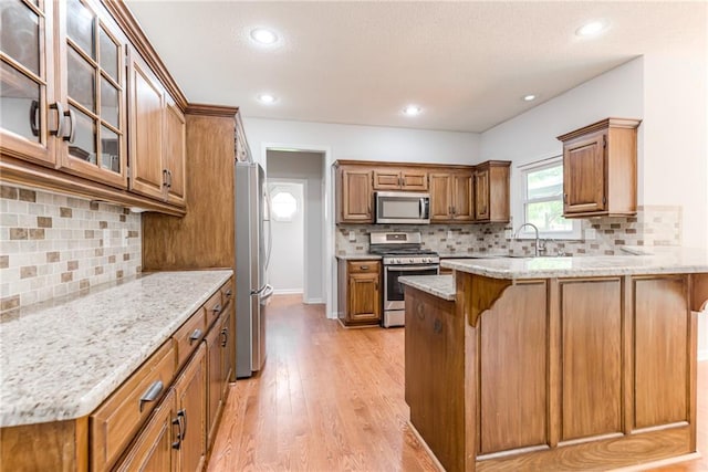 6402 W 147th Ter, Overland Park, KS 66223 - kitchen featuring stainless steel appliances, a peninsula, a kitchen bar, backsplash, and recessed lighting