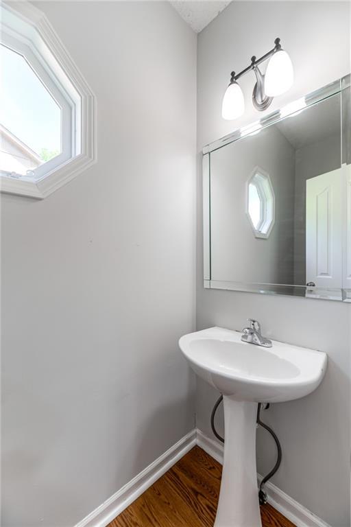 6402 W 147th Ter, Overland Park, KS 66223 - bathroom featuring wood finished floors and baseboards