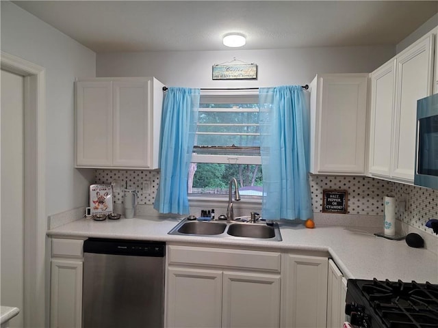 529 S Northern Blvd, Sugar Creek, MO 64054 - kitchen with stainless steel appliances, a sink, decorative backsplash, white cabinetry, and light countertops