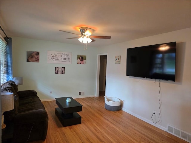 529 S Northern Blvd, Sugar Creek, MO 64054 - living area featuring ceiling fan, light wood finished floors, and baseboards