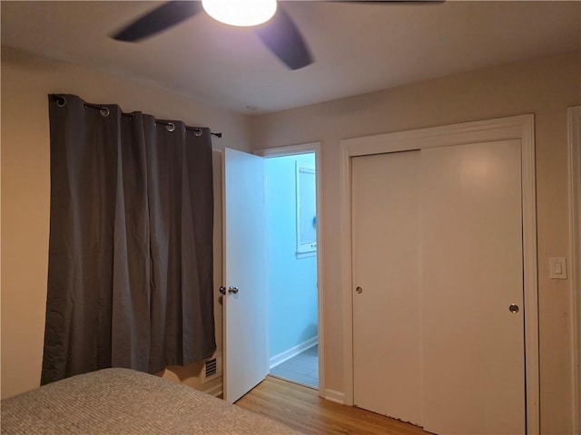 529 S Northern Blvd, Sugar Creek, MO 64054 - bedroom featuring light wood finished floors, ceiling fan, a closet, and baseboards