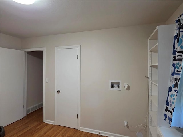 529 S Northern Blvd, Sugar Creek, MO 64054 - laundry area with washer hookup, light wood-style flooring, and baseboards