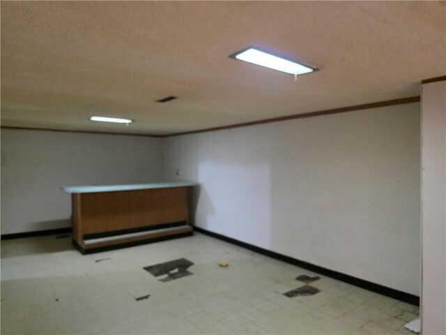 529 S Northern Blvd, Sugar Creek, MO 64054 - spare room with tile patterned floors, crown molding, and baseboards