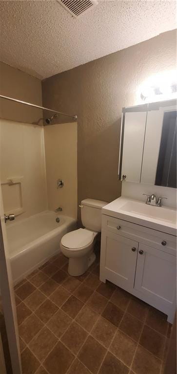 2219 E 75th St, Kansas City, MO 64132 - full bathroom featuring a textured ceiling, a textured wall, tub / shower combination, vanity, and toilet