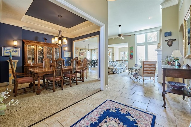 dining area with crown molding, ceiling fan, a chandelier, and baseboards