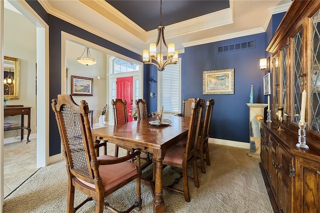 dining space with a chandelier, a tray ceiling, ornamental molding, light carpet, and baseboards
