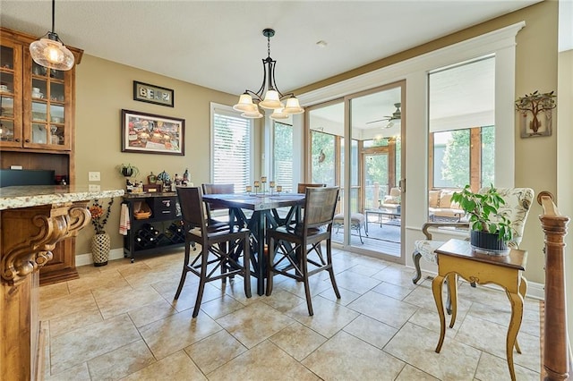 dining area featuring healthy amount of natural light, baseboards, and light tile patterned floors