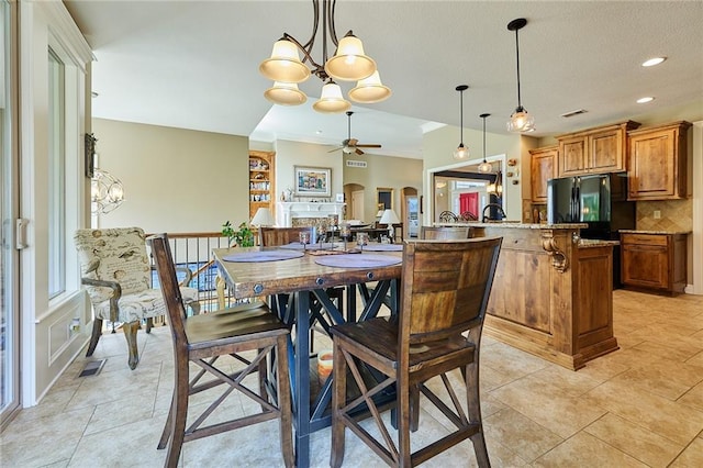 dining room featuring a chandelier, a ceiling fan, light tile patterned floors, recessed lighting, and arched walkways