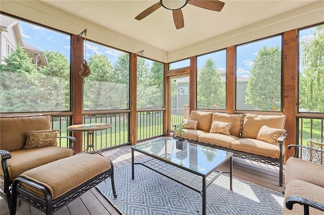 sunroom / solarium with ceiling fan, plenty of natural light, and outdoor lounge area