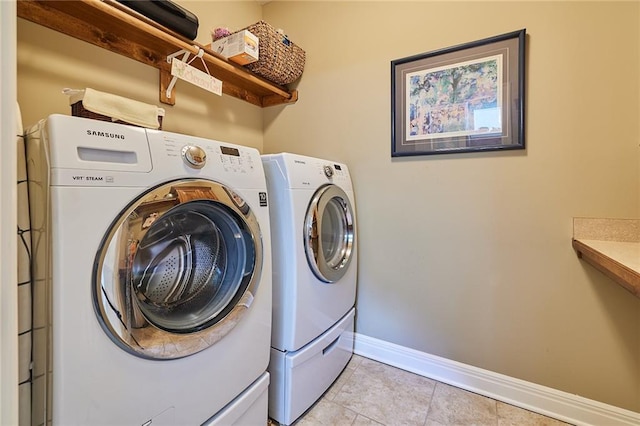 washroom with independent washer and dryer, baseboards, and light tile patterned floors