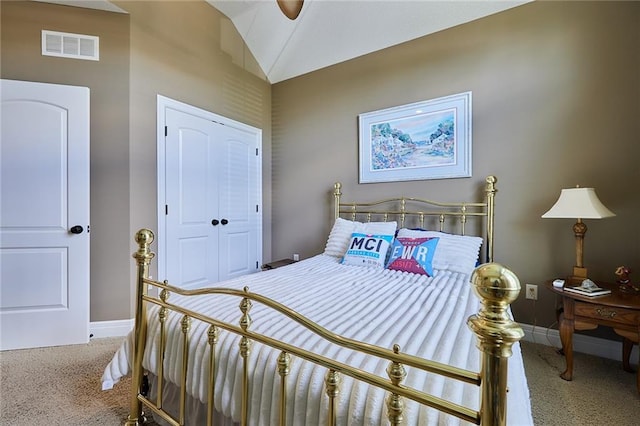 bedroom with carpet floors, baseboards, a closet, and vaulted ceiling