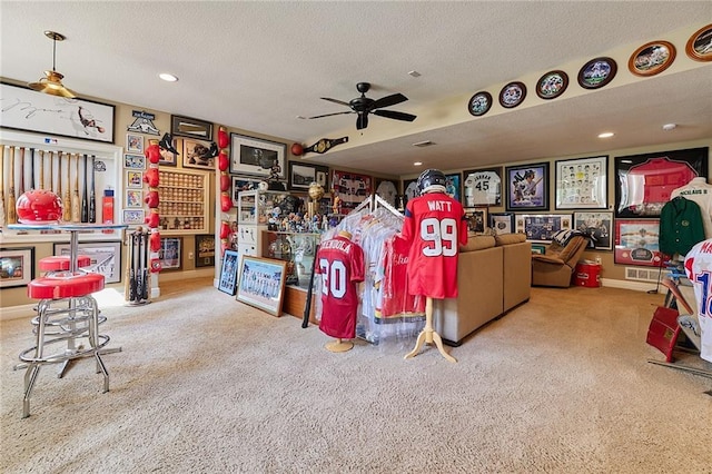 living room featuring carpet, ceiling fan, a textured ceiling, and recessed lighting