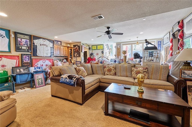 carpeted living area with healthy amount of natural light, a textured ceiling, a ceiling fan, and recessed lighting