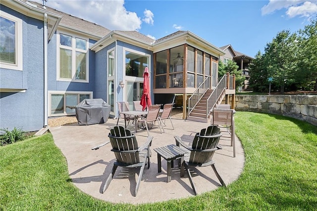 view of patio / terrace with a sunroom and stairway