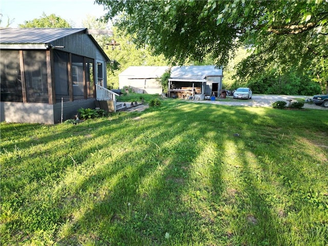 view of green lawn with a sunroom