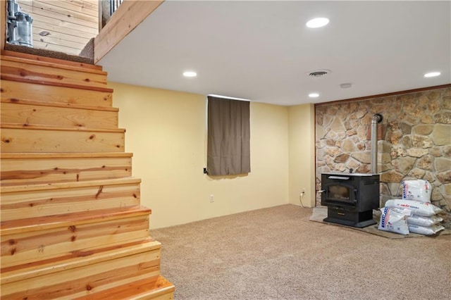 429 SE Lakeside Dr, Lacygne, KS 66040 - unfurnished living room with carpet flooring, a wood stove, recessed lighting, and stairs