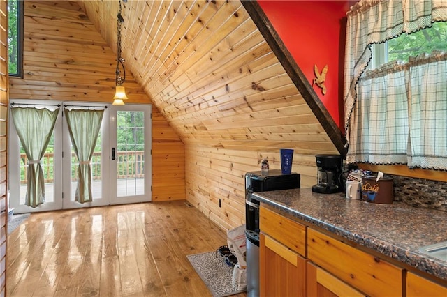 429 SE Lakeside Dr, Lacygne, KS 66040 - kitchen featuring vaulted ceiling, wooden walls, plenty of natural light, wooden ceiling, and light wood-style flooring