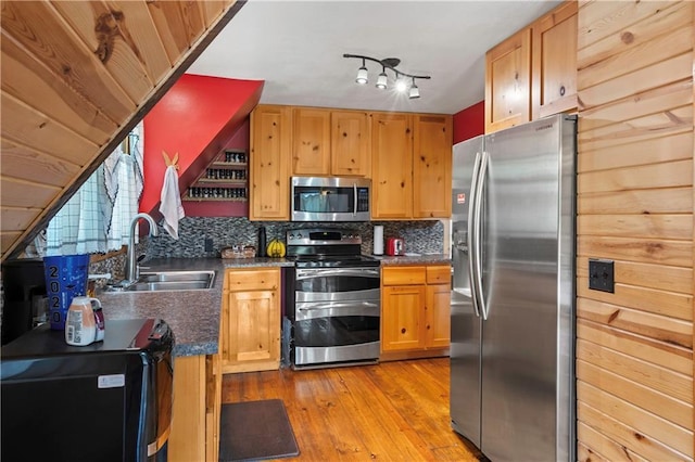 429 SE Lakeside Dr, Lacygne, KS 66040 - kitchen featuring stainless steel appliances, a sink, dark countertops, and backsplash