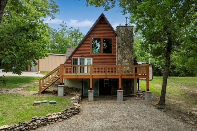 429 SE Lakeside Dr, Lacygne, KS 66040 - back of property featuring a deck, log veneer siding, a yard, and a chimney
