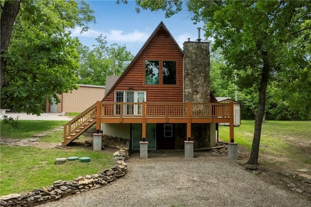 429 SE Lakeside Dr, Lacygne, KS 66040 - back of property featuring faux log siding, a deck, a lawn, and stairs