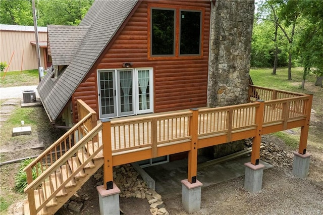 429 SE Lakeside Dr, Lacygne, KS 66040 - back of property with a deck, a shingled roof, log veneer siding, and stairway