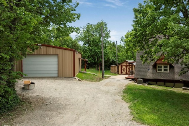 429 SE Lakeside Dr, Lacygne, KS 66040 - detached garage featuring central AC unit and driveway