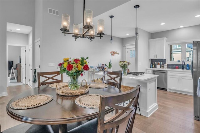 522 NW 110th St, Kansas City, MO 64155 - dining room with light wood finished floors, recessed lighting, and a chandelier