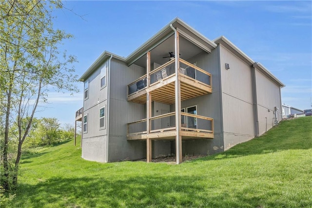 522 NW 110th St, Kansas City, MO 64155 - back of house featuring ceiling fan, a balcony, a lawn, and a deck