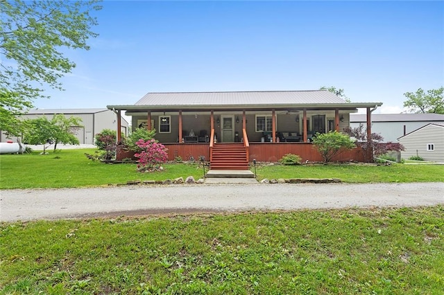 336 SE Zack Wheat Dr, Polo, MO 64671 - view of front of property with covered porch, a front yard, and metal roof