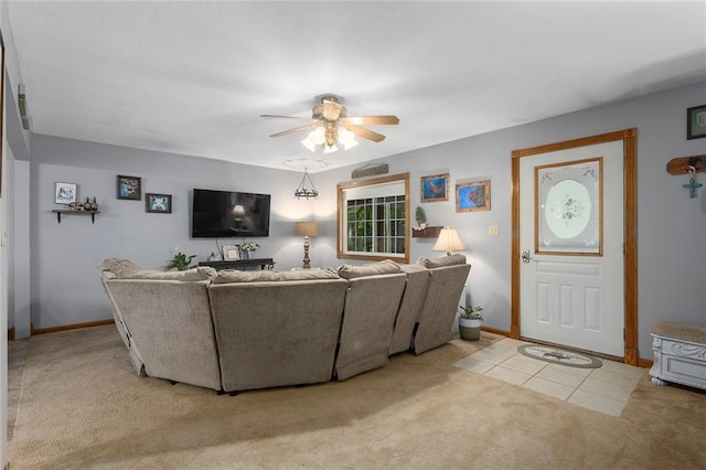 336 SE Zack Wheat Dr, Polo, MO 64671 - living room featuring light colored carpet, a ceiling fan, baseboards, and light tile patterned floors