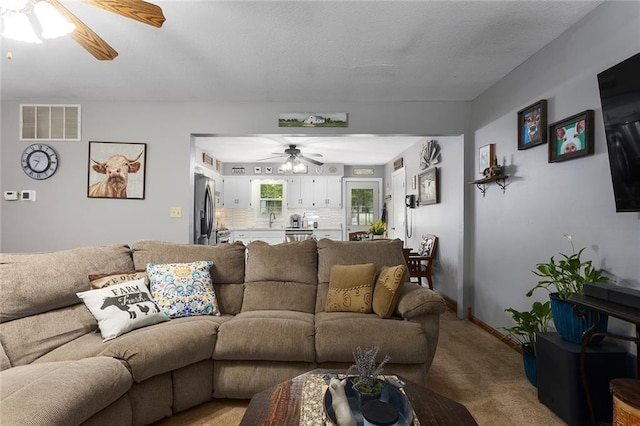 336 SE Zack Wheat Dr, Polo, MO 64671 - living area featuring a ceiling fan and light colored carpet