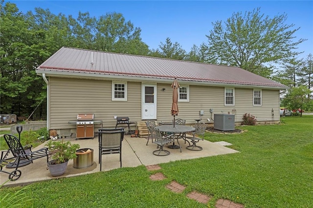 336 SE Zack Wheat Dr, Polo, MO 64671 - back of house with a yard, a patio, central AC unit, and metal roof