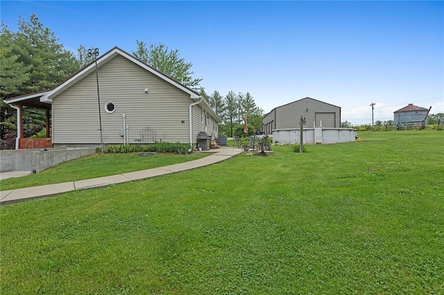 336 SE Zack Wheat Dr, Polo, MO 64671 - view of side of home featuring a detached garage and a lawn