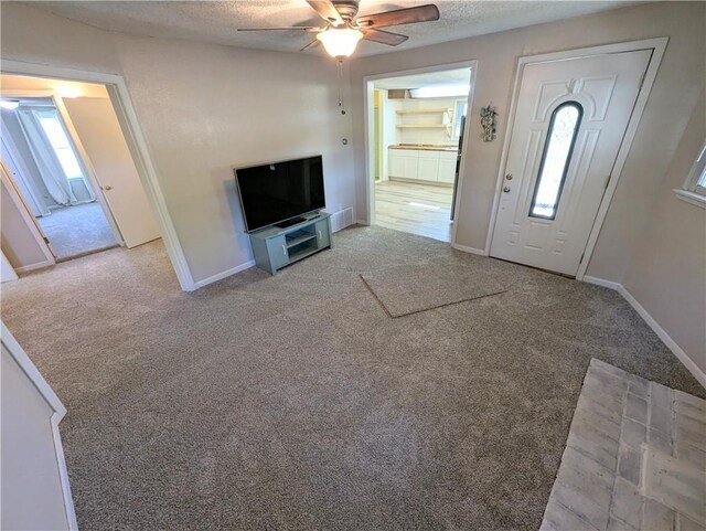 528 W Ashland St, Nevada, MO 64772 - entryway featuring carpet floors, a ceiling fan, baseboards, and a textured ceiling