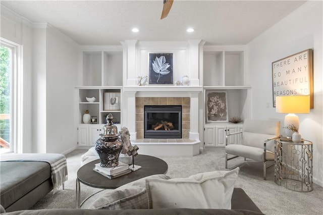 4612 Roberts St, Shawnee, KS 66226 - carpeted living area featuring a fireplace, built in shelves, ornamental molding, a ceiling fan, and recessed lighting