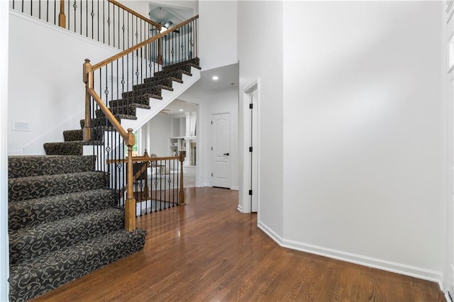 4612 Roberts St, Shawnee, KS 66226 - stairway featuring wood finished floors and a towering ceiling