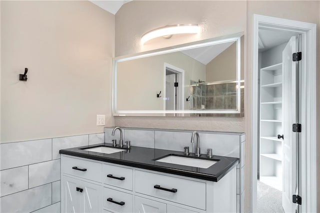 4612 Roberts St, Shawnee, KS 66226 - full bathroom featuring vaulted ceiling, double vanity, tile walls, and built in features